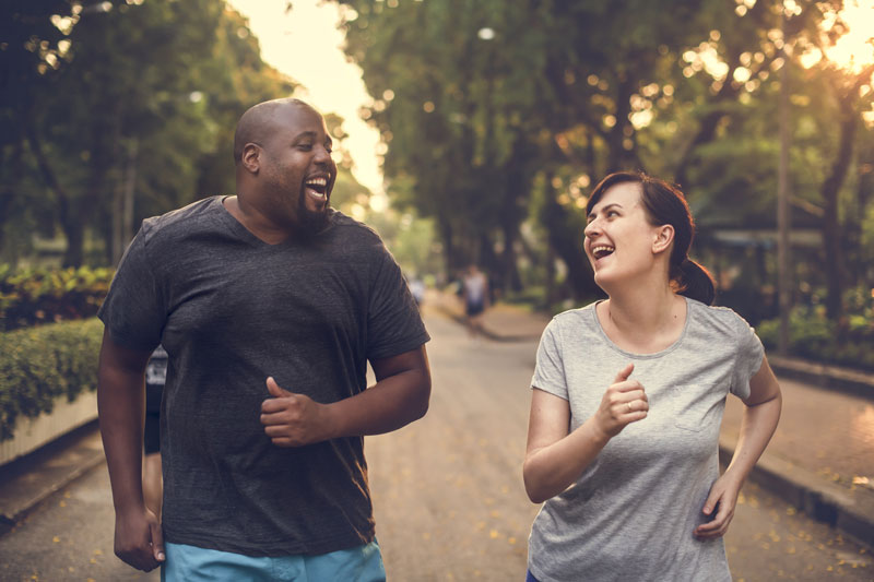 man and woman running and smiling